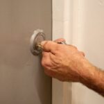 A hand unlocking a door with a key